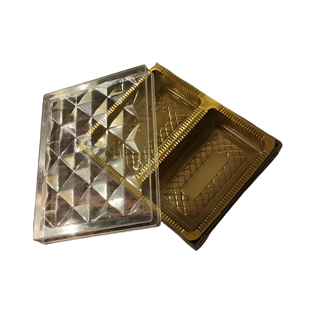 A transparent rectangular crystal box with two cavities, one of which is shown to contain a golden-colored object, possibly a crystal or a piece of fruit.